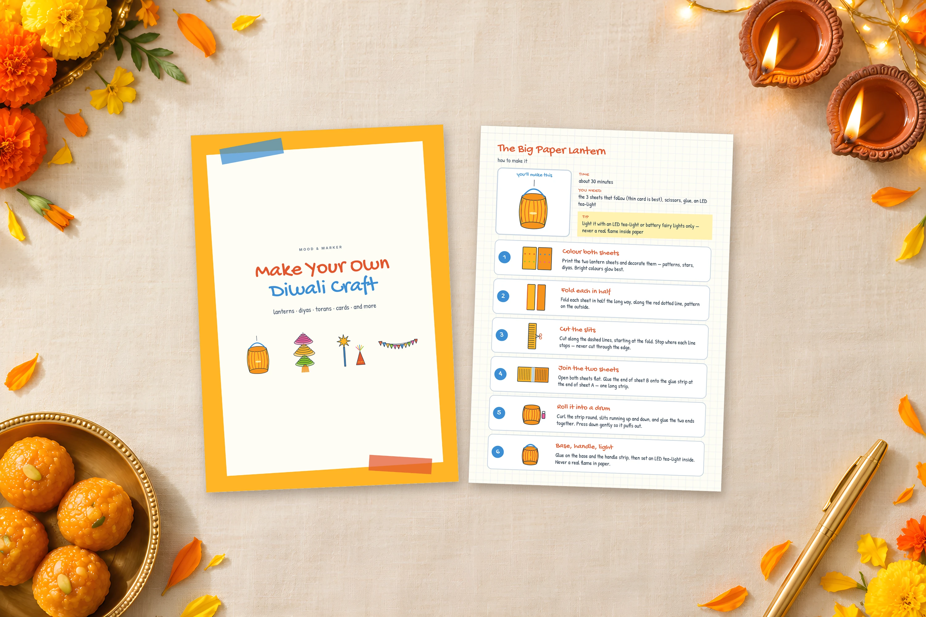 The cover and the lantern how-to page on a cream cloth with diyas, marigolds and laddoos