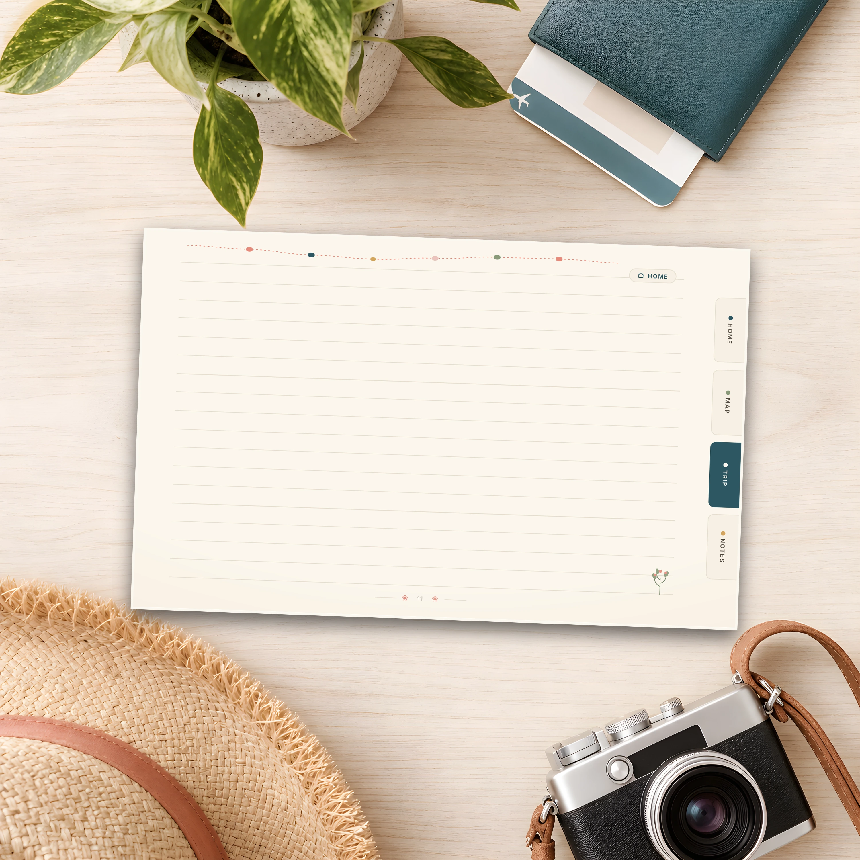 A blank lined day-diary page, ready for the day's story, beside a straw hat and camera